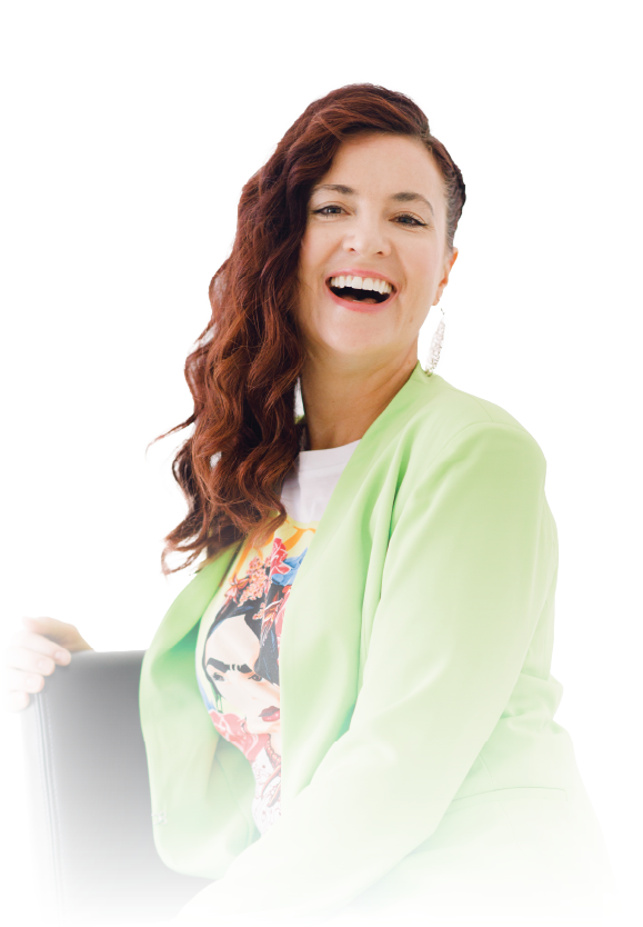 Smiling person with wavy auburn hair in a light green jacket against a white background