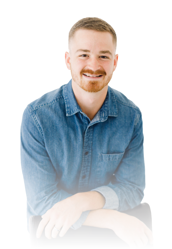 Smiling man in a blue denim shirt against a white background