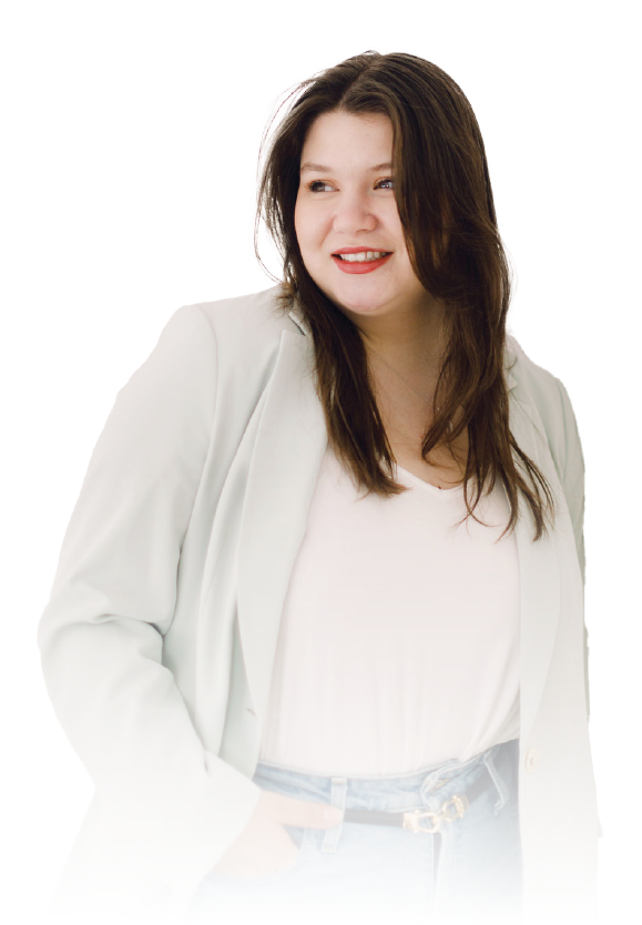 Woman in a white blazer and blouse, smiling and looking to the side against a white background