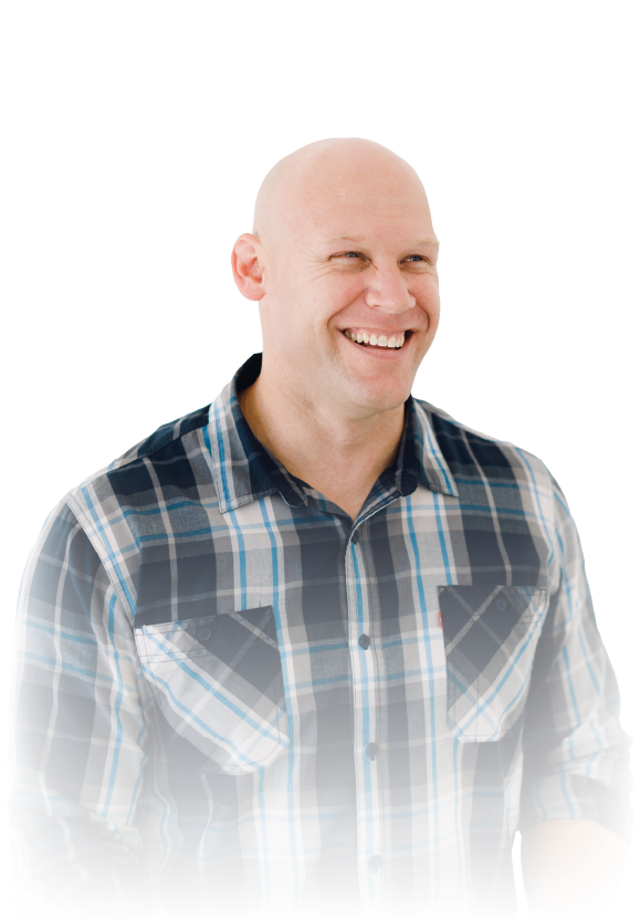 Smiling bald man in a blue plaid shirt on a white background