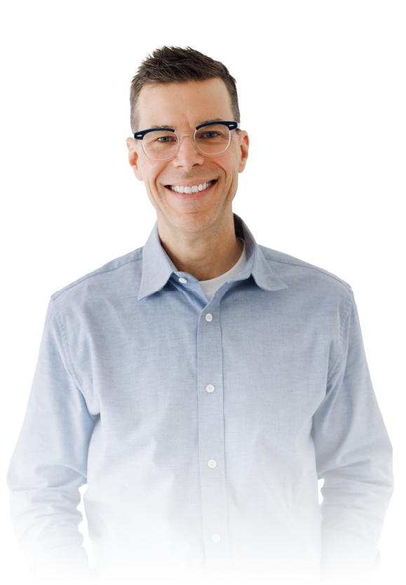 Smiling person in glasses wearing a light blue button-up shirt on a white background