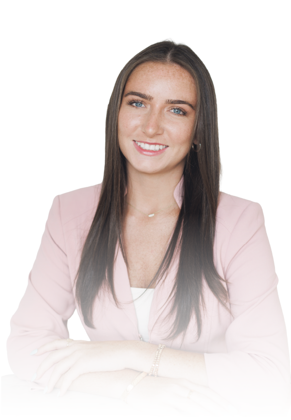 Smiling woman in a light pink blazer against a white background