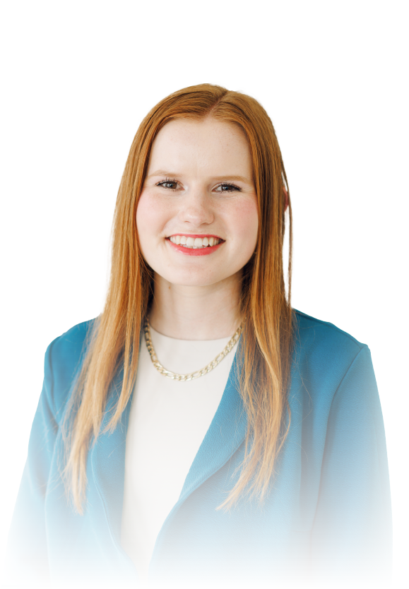 Smiling woman with long red hair in a blue blazer on a white background