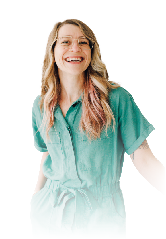 Smiling woman in a teal blouse against a white background