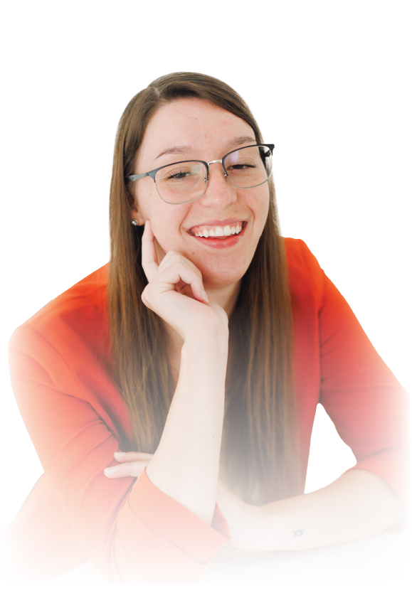 Smiling person with glasses and long brown hair, resting chin on hand against a white background
