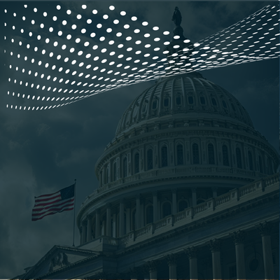 U.S. Capitol dome under a dotted light canopy, with a waving American flag in the foreground