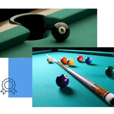 Billiard balls on a green pool table, with a cue stick and an 8-ball near a pocket.