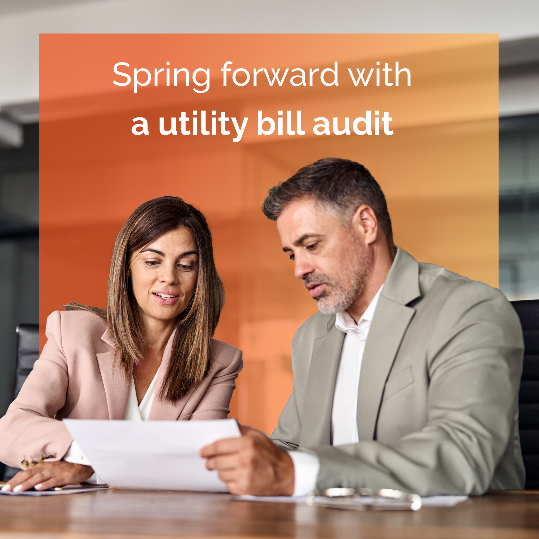 Two people review a bill at a desk under the text “Spring forward with a utility bill audit”