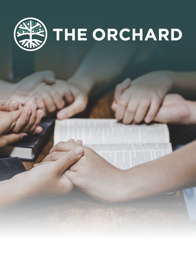 Hands gathered in prayer around an open Bible under The Orchard logo.