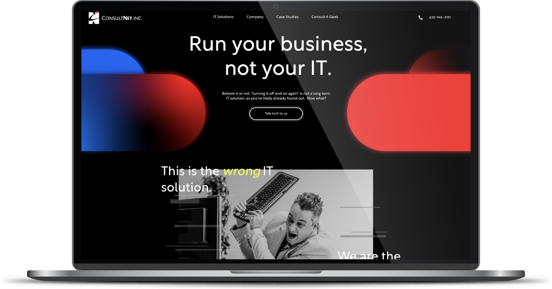 Laptop displaying a dark website mockup with red and blue accents and the headline “Run your business, not your IT.”
