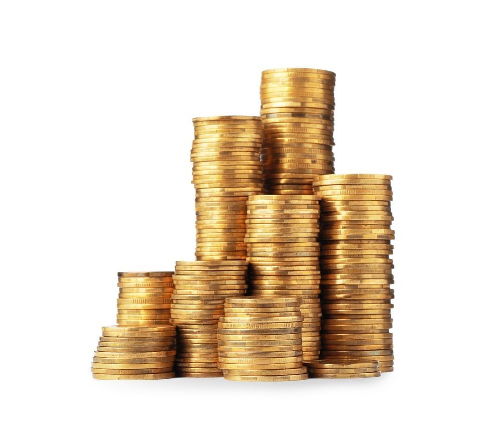 Stacks of gold coins arranged in varying heights on a white background