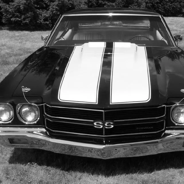 Front view of a classic black Chevrolet SS with white racing stripes parked outdoors