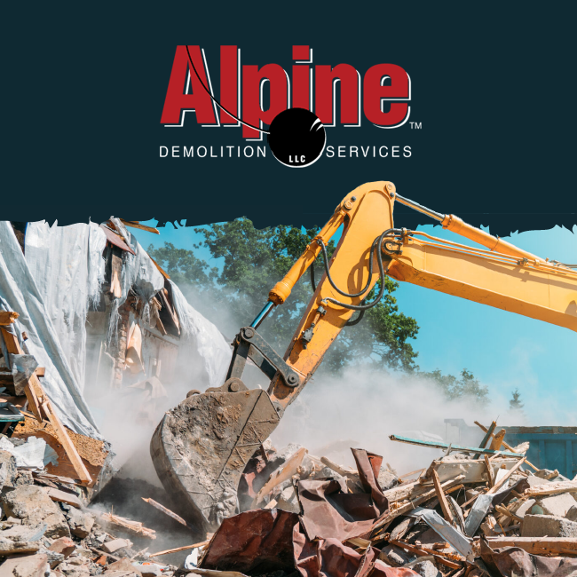 Alpine Demolition Services excavator tearing down a building amid dust and debris