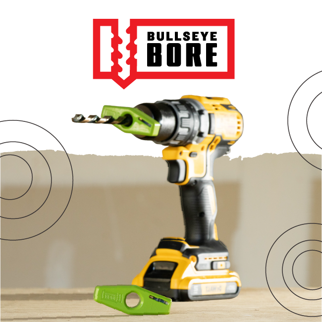 Bullseye Bore logo above a yellow cordless drill with a green attachment on a workbench.