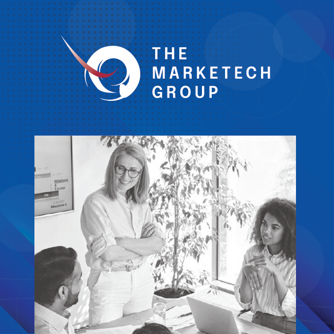 The Marketech Group logo above a grayscale office meeting with three people around a laptop