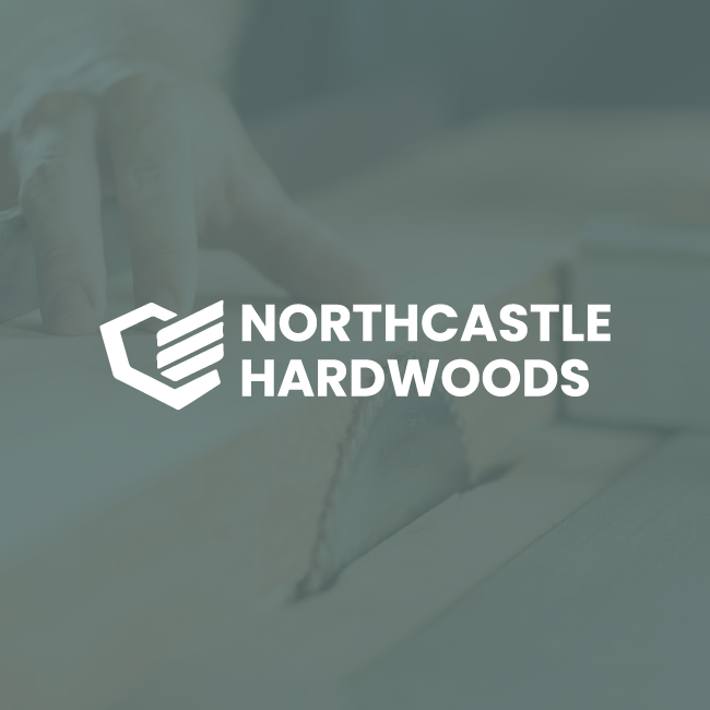 Northcastle Hardwoods logo in white over a muted wood-cutting background