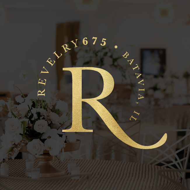 Gold “R” logo for Revery 675 Bath III over a soft, blurred floral and dining room background