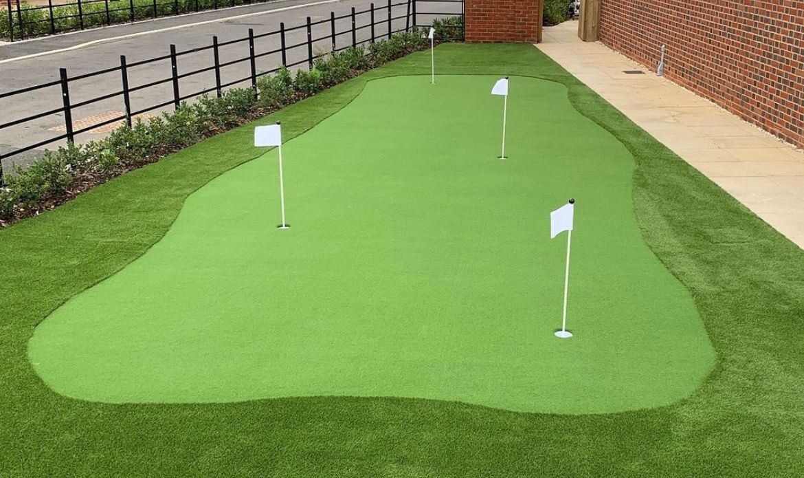 there is a small golf course in the backyard of a house