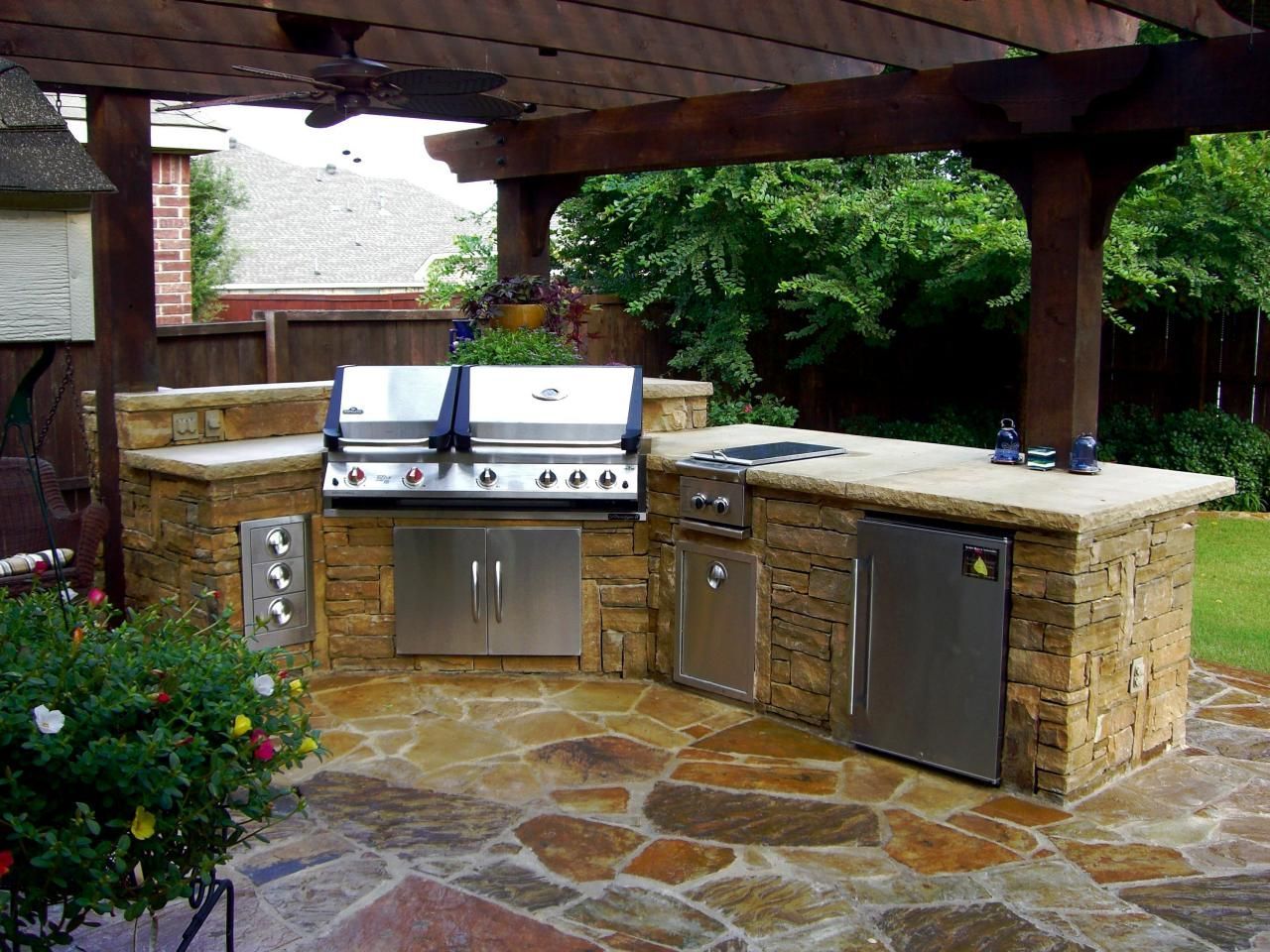 Luxury outdoor kitchen with gas grill, refrigerator, and pergola | J Gonzalez