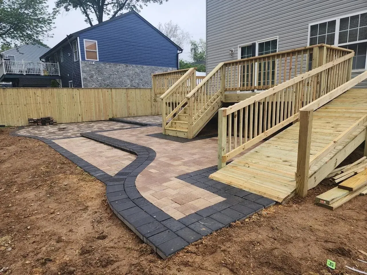 Custom deck and patio combo with ramp and staircase installed by J Gonzalez Construction in Maryland