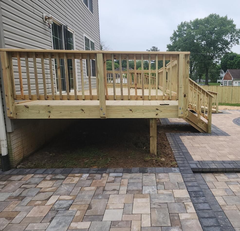 A wooden deck with stairs leading up to it