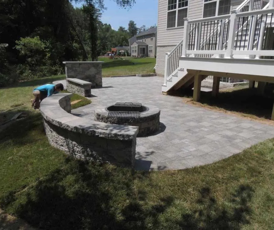 Wooden retaining wall on a hillside, constructed of planks and posts, in an outdoor setting.