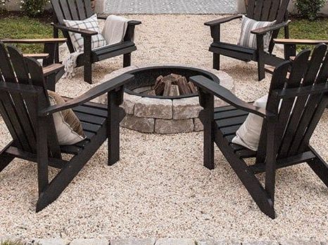 A group of chairs sitting around a fire pit.