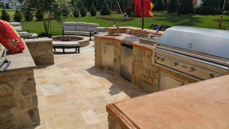 New patio with built-in outdoor kitchen featuring grill and counter space