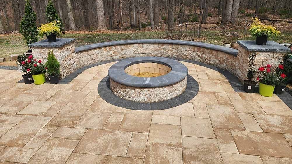 Custom patio with fire pit and retaining wall in Maryland by J Gonzalez Construction