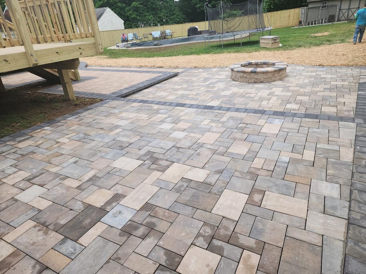 There is a fire pit in the middle of the patio.