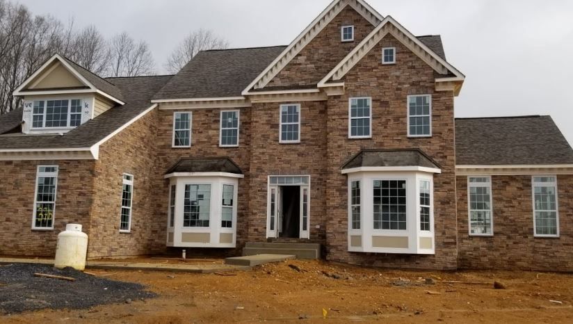 A large brick house with a gray roof