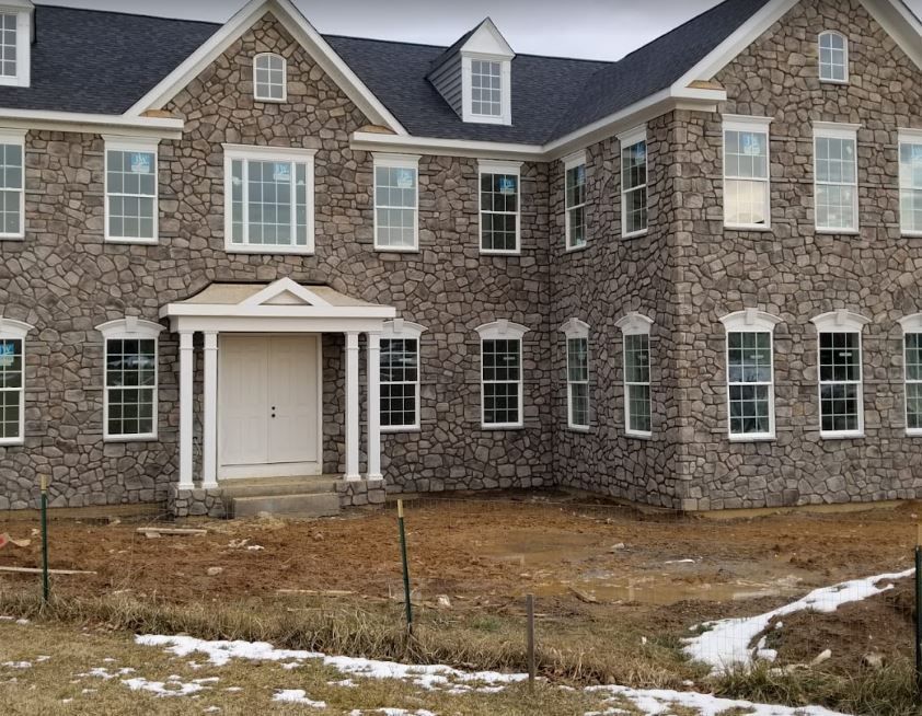 A large stone house with a lot of windows