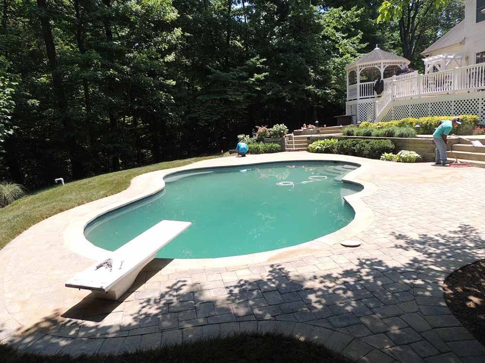 A large swimming pool with a diving board in the middle