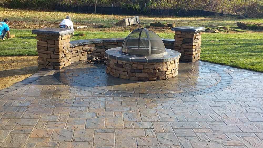 A fire pit is sitting on top of a brick patio in Maryland