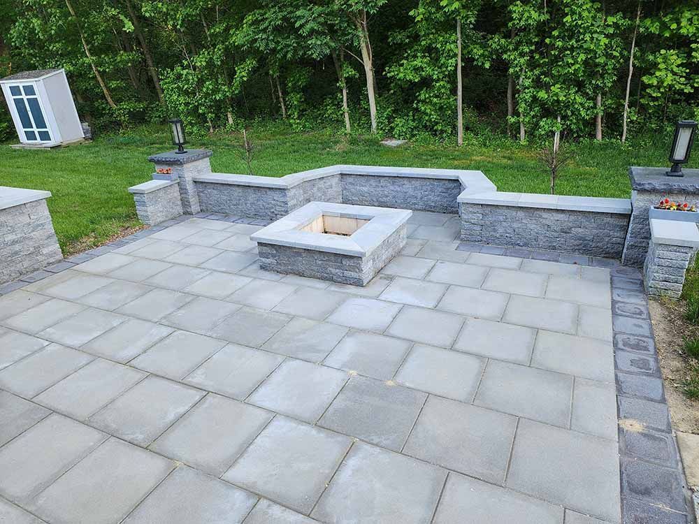 There is a fire pit in the middle of the patio.