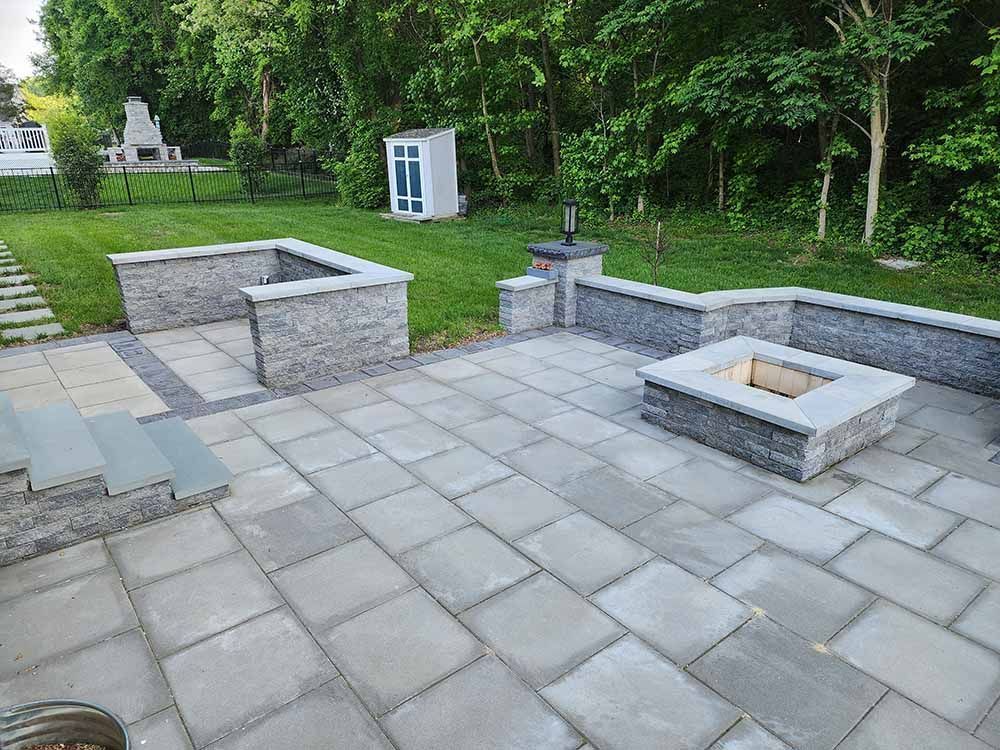 There is a fire pit in the middle of the patio.