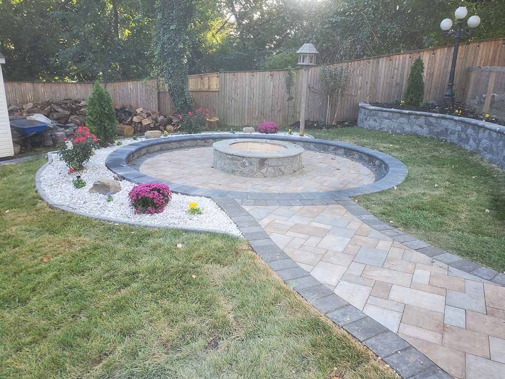 There is a fire pit in the middle of the backyard.