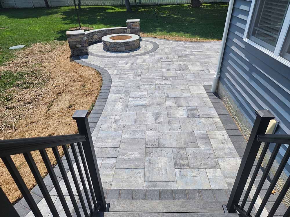 There is a fire pit in the middle of the patio.