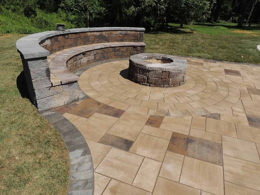 There is a fire pit in the middle of the patio.