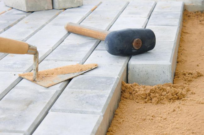 hammer and trowel in the brick stone