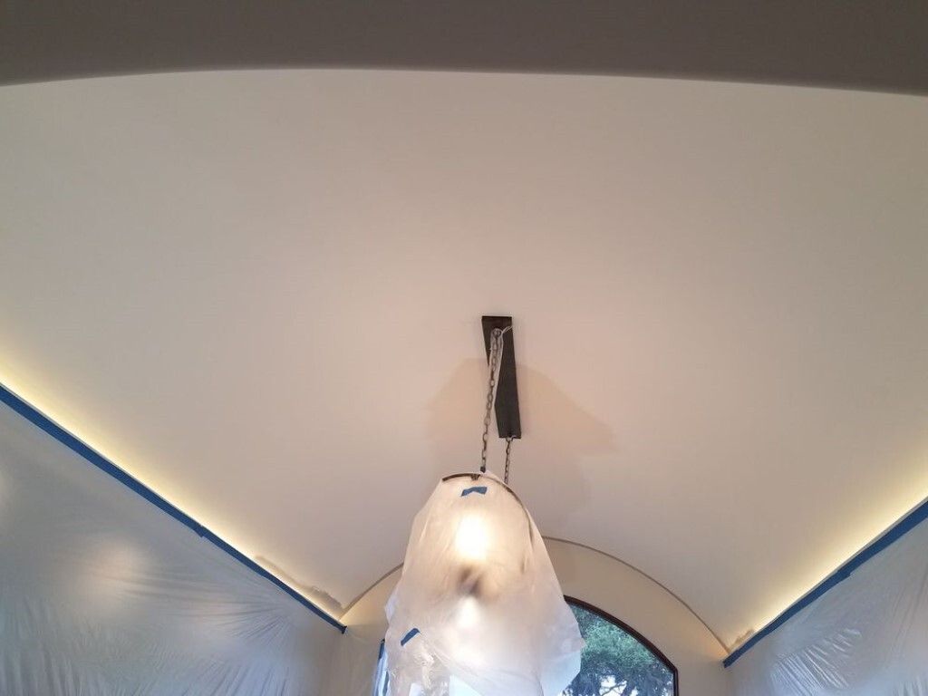 A light fixture is hanging from the ceiling of a room.