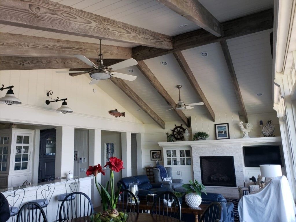 A living room with a fireplace and ceiling fans