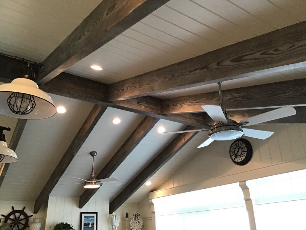 A ceiling fan is hanging from the ceiling of a room.