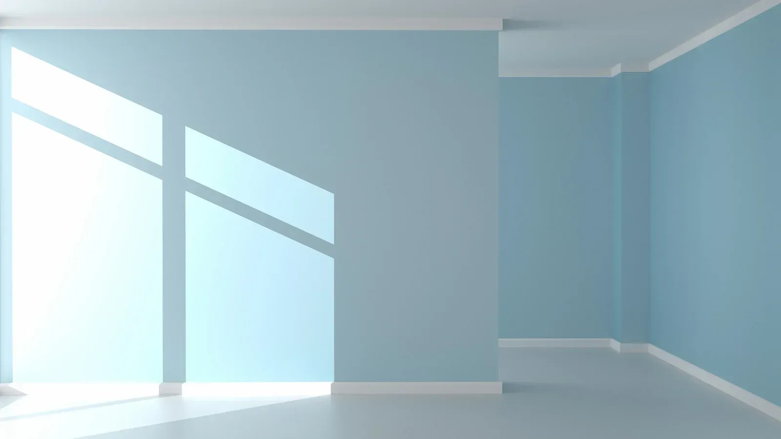 An empty room with blue walls and a large window.