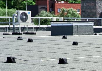 The roof of a building with a ventilation system on it.