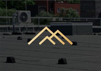 A logo for a company is on the roof of a building.