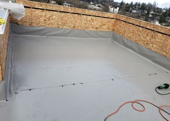 A roof with a roofing material being installed on it.