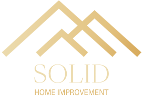 A logo for solid home improvement with a mountain in the background.