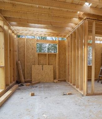 A room that is being built with a lot of wood