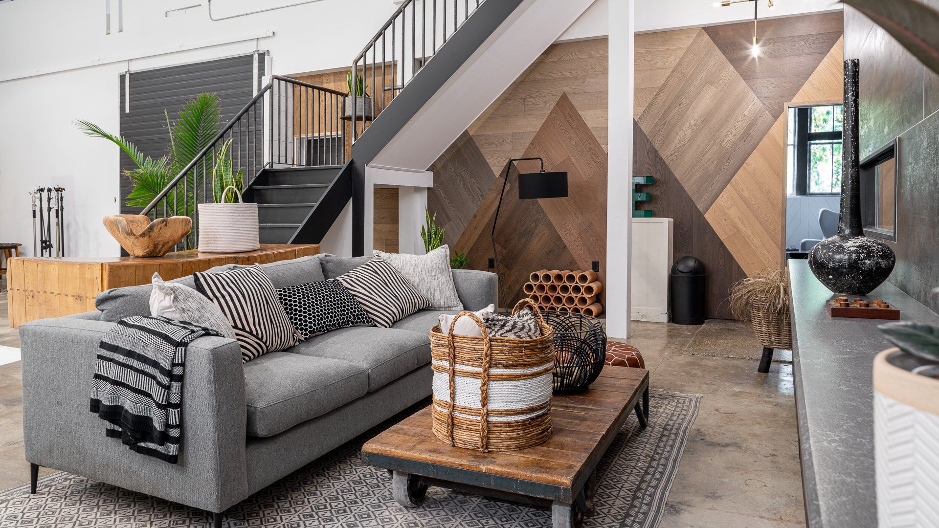 a living room with a couch , coffee table , and stairs .